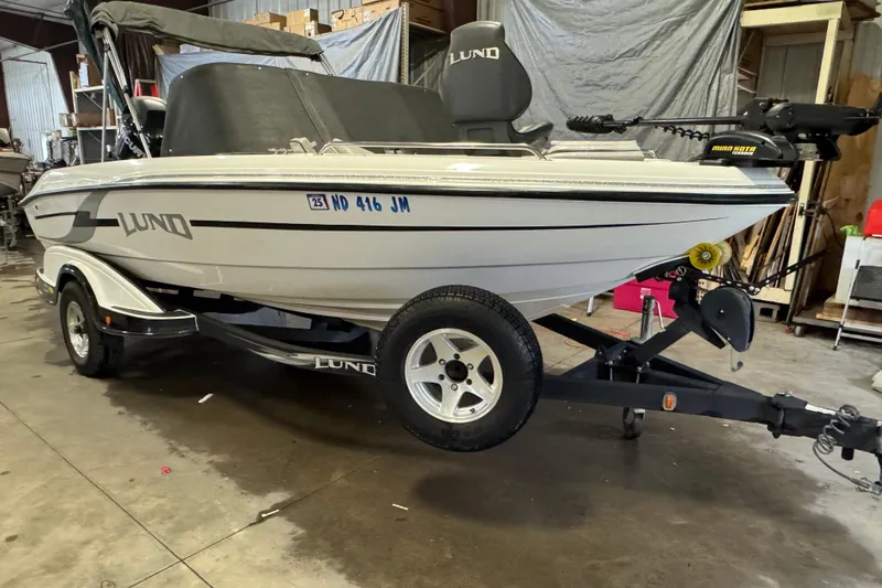 Slide: The Image of 2009 Lund 186 Tyee GL boat on trailer in a garage setting. - 2