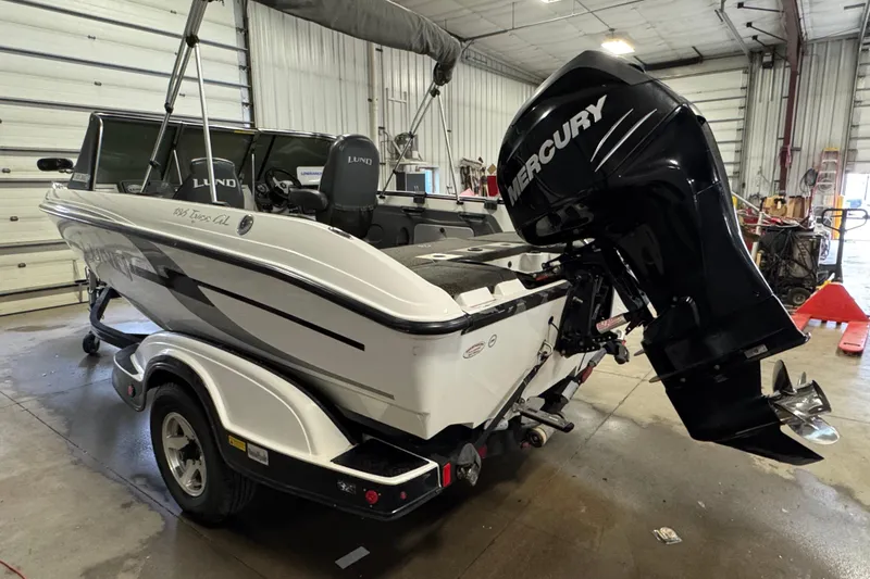 Slide: The Image of 2009 Lund 186 Tyee GL boat with Mercury outboard motor in a garage. - 4
