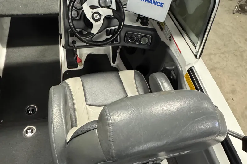 Slide: The Image of 2009 Lund 186 Tyee GL boat interior with steering wheel and seat. - 6