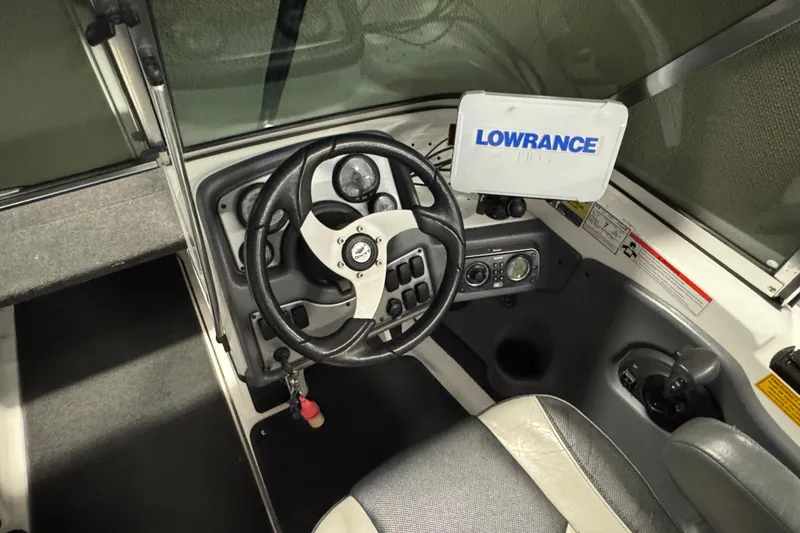 Slide: The Image of 2009 Lund 186 Tyee GL boat cockpit with steering wheel and Lowrance navigation system. - 7