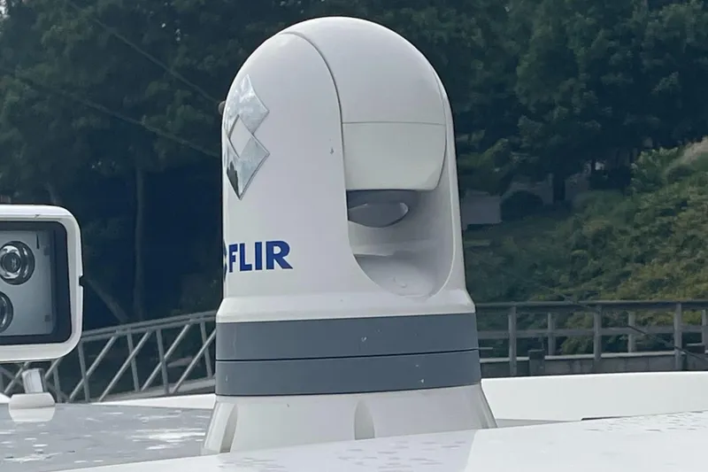 Slide: The Image of FLIR camera on 2023 Pursuit OS 445 Offshore boat, surrounded by greenery. - 16