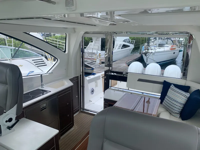 Slide: The Image of Interior of 2023 Pursuit OS 445 Offshore yacht, featuring modern seating and sleek design. - 7