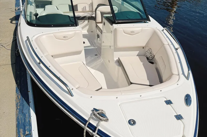 Slide: The Image of 2017 Chaparral 227 SSX boat with spacious seating, docked by the water. - 11
