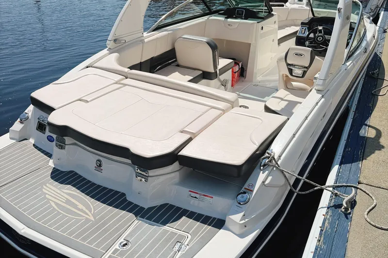 Slide: The Image of 2017 Chaparral 227 SSX boat with spacious seating and sleek design docked by the water. - 14