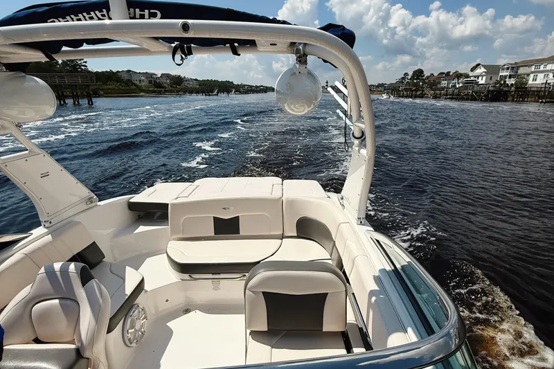 Slide: The Image of 2017 Chaparral 227 SSX boat cruising on a sunny day, with scenic waterfront views. - 17