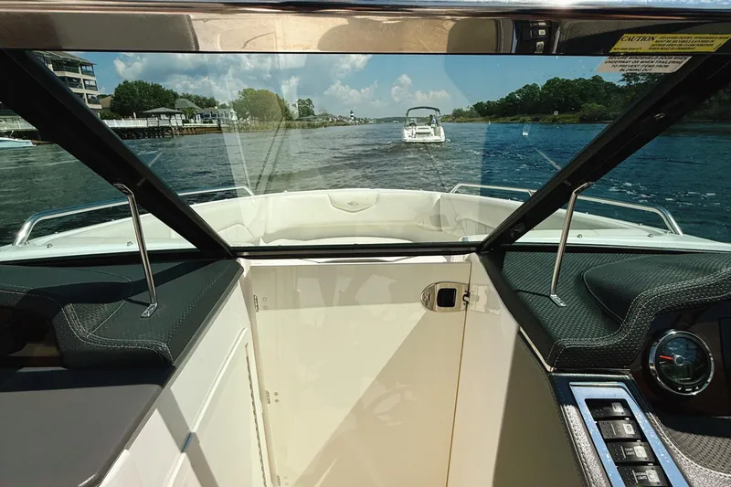 Slide: The Image of 2017 Chaparral 227 SSX boat interior view with dashboard and waterway scenery. - 21