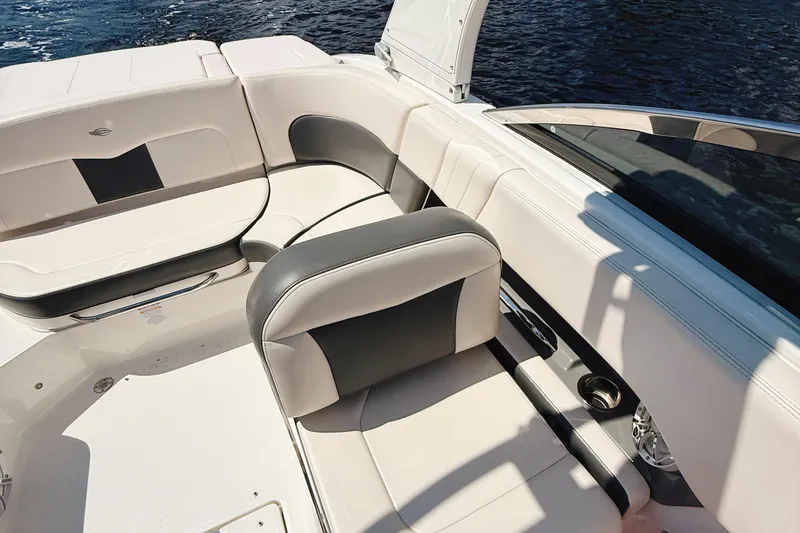 Slide: The Image of 2017 Chaparral 227 SSX boat interior with white and gray seating, on water. - 23