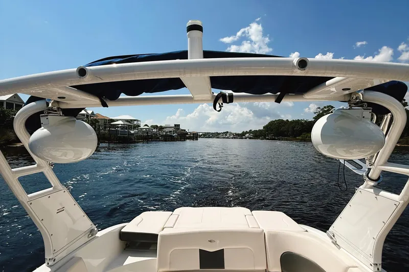 Slide: The Image of 2017 Chaparral 227 SSX boat cruising on a sunny day, with scenic waterfront views. - 24