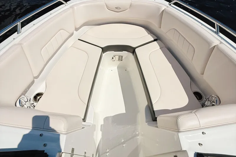 Slide: The Image of 2017 Chaparral 227 SSX boat interior with white cushioned seating and cup holders. - 26