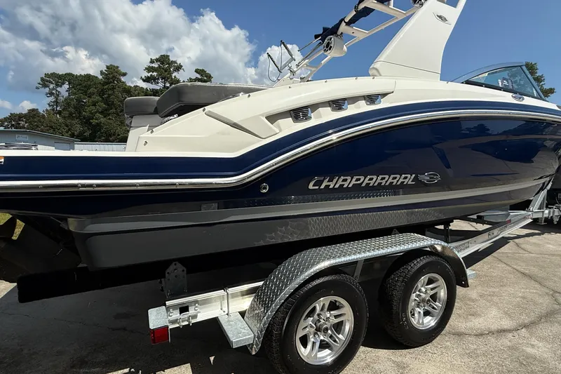 Slide: The Image of 2017 Chaparral 227 SSX boat on trailer, side view, blue and white design. - 7