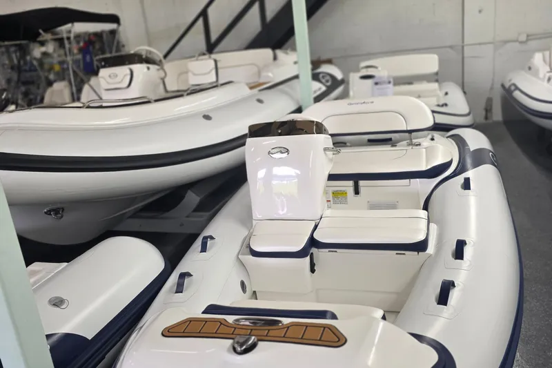 Slide: The Image of 2025 Walker Bay Generation 12 LTE inflatable boat in showroom, featuring sleek white design. - 1
