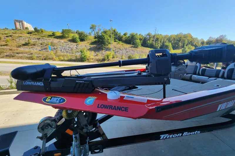 Slide: The Image of Triton TX17 boat with Lowrance equipment, 2006 model, parked outdoors on a sunny day. - 3