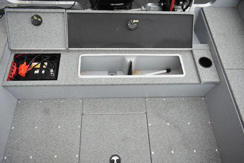 Slide: The Image of 2024 Lund 1875 Alaskan Sport boat interior with storage compartments and battery. - 10