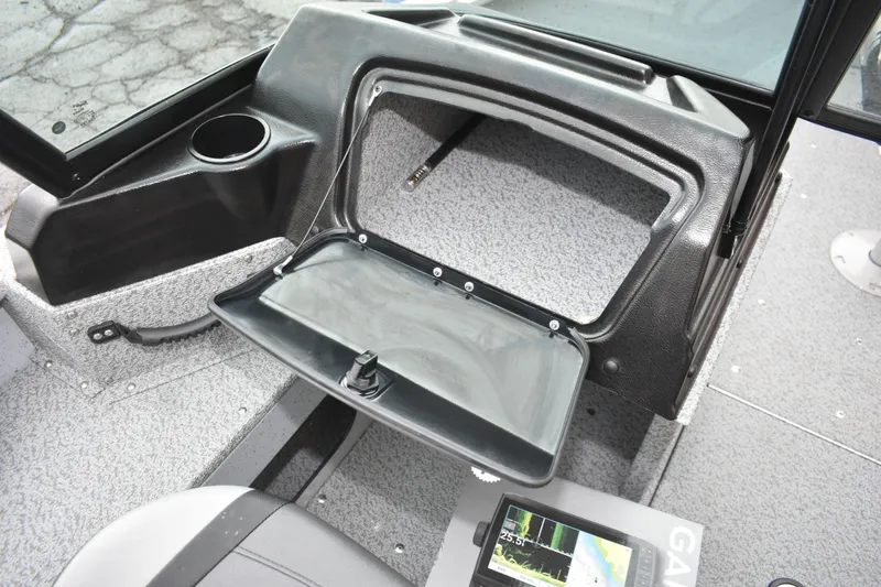 Slide: The Image of 2024 Lund 1875 Alaskan Sport boat interior with open storage compartment and navigation display. - 14