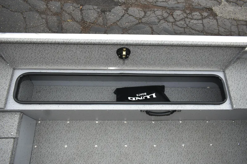Slide: The Image of 2024 Lund 1875 Alaskan Sport boat storage compartment with Lund branded bag. - 16
