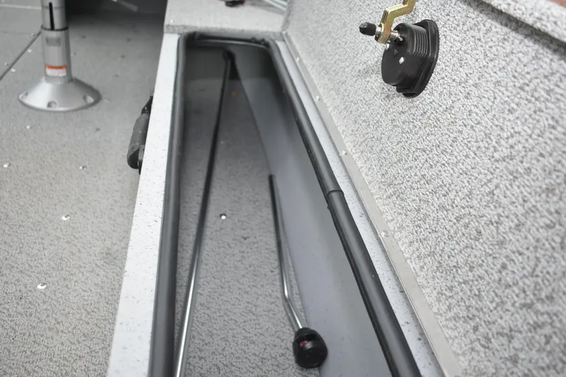 Slide: The Image of 2024 Lund 1875 Alaskan Sport boat interior storage compartment with fishing rod holder. - 18