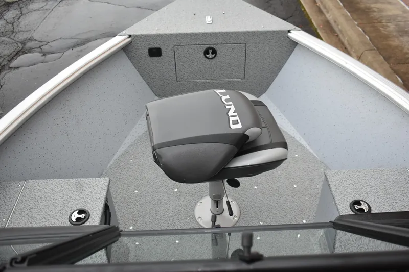 Slide: The Image of 2024 Lund 1875 Alaskan Sport boat interior with swivel seat and storage compartments. - 19