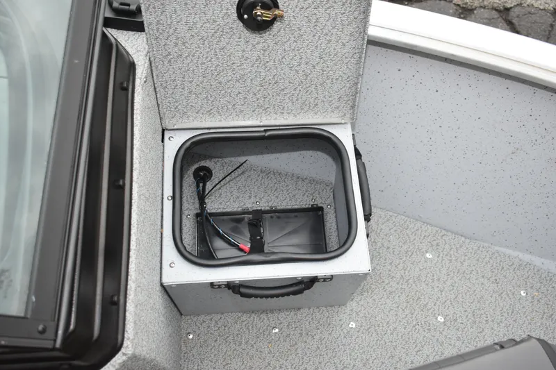 Slide: The Image of 2024 Lund 1875 Alaskan Sport boat storage compartment with wiring and textured interior. - 21
