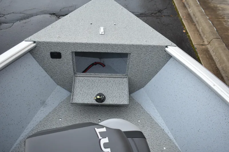 Slide: The Image of 2024 Lund 1875 Alaskan Sport boat interior, featuring storage compartment and durable flooring. - 22