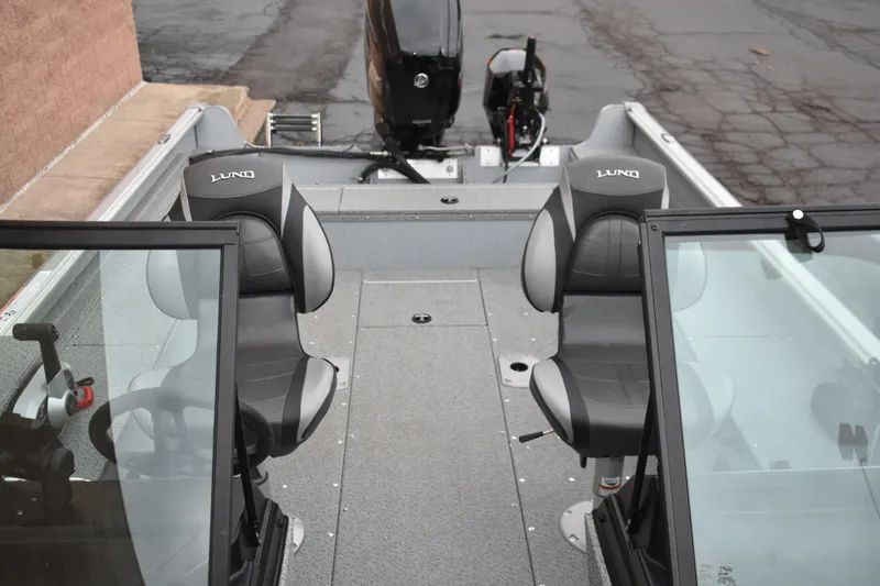 Slide: The Image of 2024 Lund 1875 Alaskan Sport boat interior with dual seats and windshield. - 23