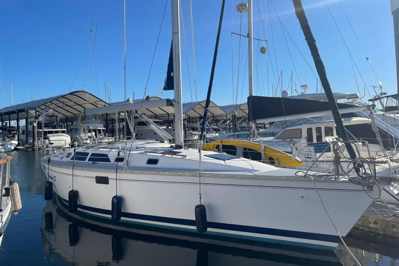 Slide: The Image of Sailboat docked at marina, 1994 Hunter Legend 37.5, under clear blue sky. - 1
