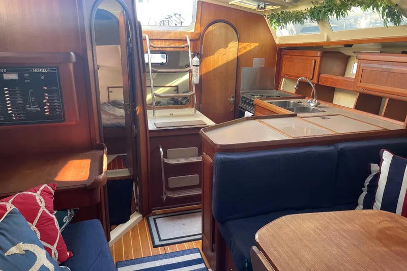 Slide: The Image of Interior of 1994 Hunter Legend 37.5 sailboat with cozy seating and kitchen area. - 10