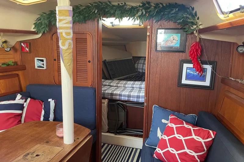 Slide: The Image of Cozy interior of 1994 Hunter Legend 37.5 sailboat with nautical decor and cushions. - 15