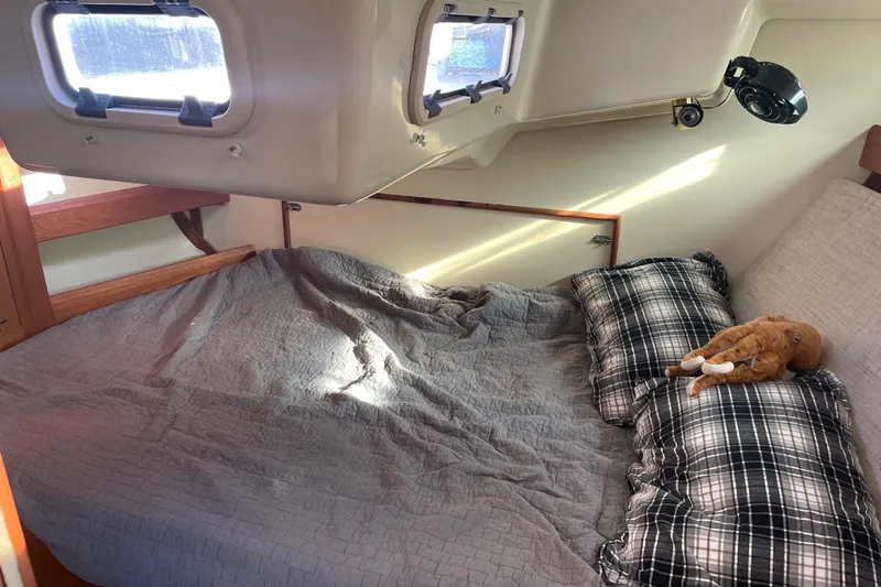 Slide: The Image of Cozy cabin interior of 1994 Hunter Legend 37.5 sailboat with bed and plaid pillows. - 18