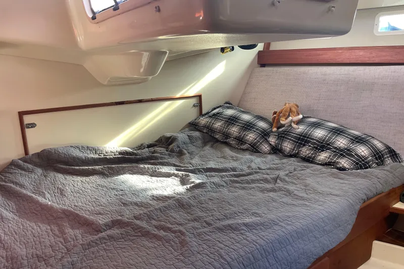 Slide: The Image of Cozy cabin interior of 1994 Hunter Legend 37.5 sailboat with plaid pillows and plush toy. - 19