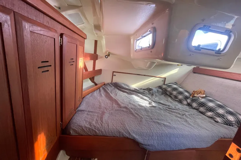 Slide: The Image of Cozy cabin interior of 1994 Hunter Legend 37.5 sailboat with bed and wooden cabinets. - 20