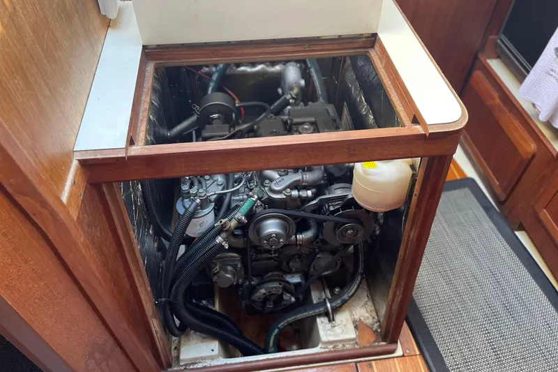 Slide: The Image of Engine compartment of a 1994 Hunter Legend 37.5 sailboat, showcasing mechanical components. - 21