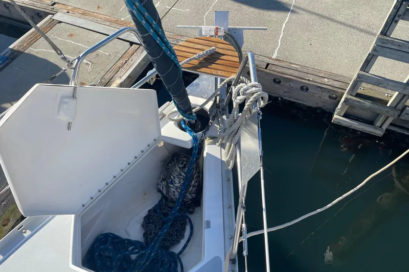Slide: The Image of 1994 Hunter Legend 37.5 sailboat anchor locker with ropes and chains at dock. - 8