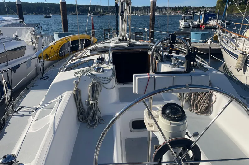 Slide: The Image of 1994 Hunter Legend 37.5 sailboat docked at marina, featuring spacious cockpit and steering wheel. - 9
