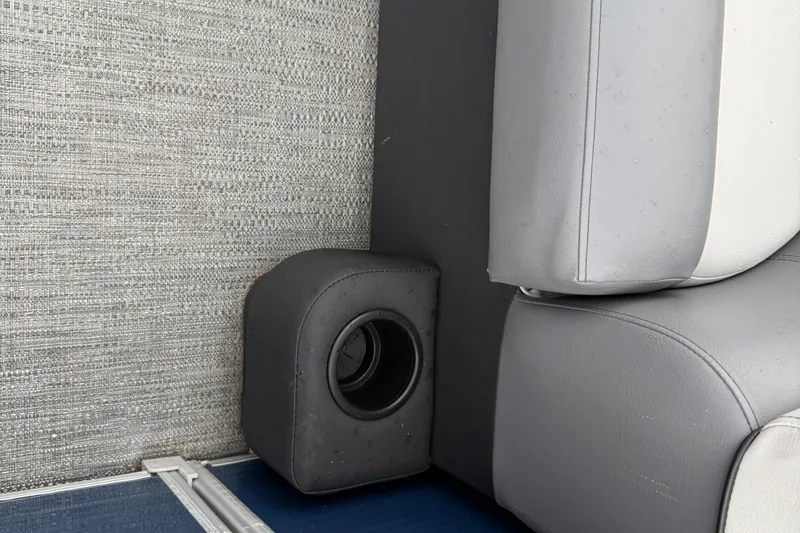 Slide: The Image of 2022 Godfrey Sweetwater boat interior with speaker and gray seating. - 11