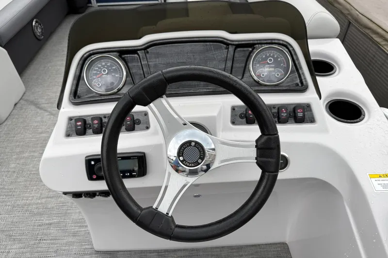 Slide: The Image of Steering console of a 2022 Godfrey Sweetwater boat with gauges and controls. - 16
