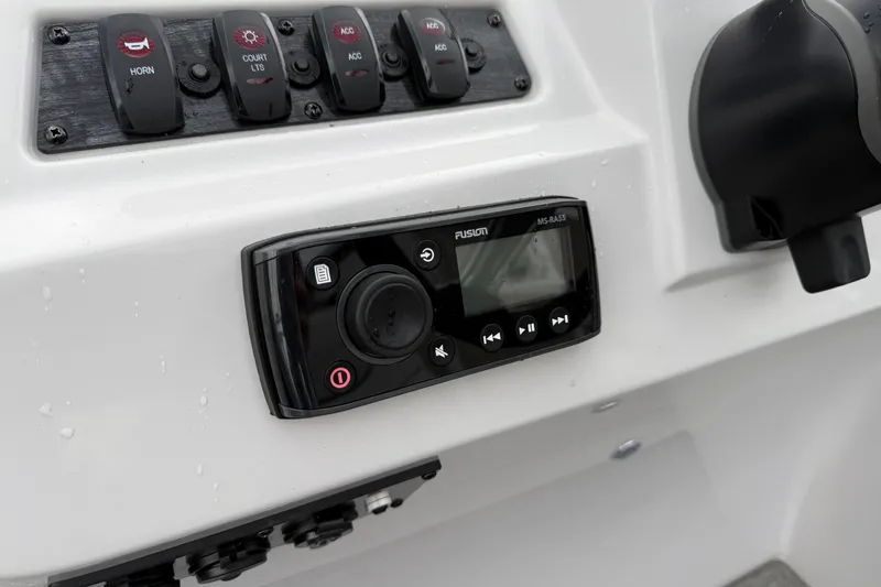 Slide: The Image of Control panel of 2022 Godfrey Sweetwater boat with Fusion audio system and switches. - 17