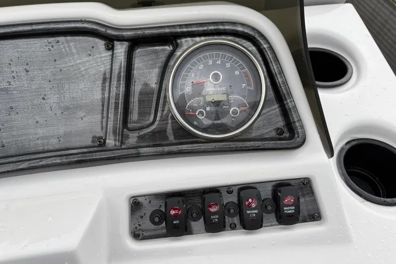 Slide: The Image of Dashboard of a 2022 Godfrey Sweetwater boat with gauges and control switches. - 20
