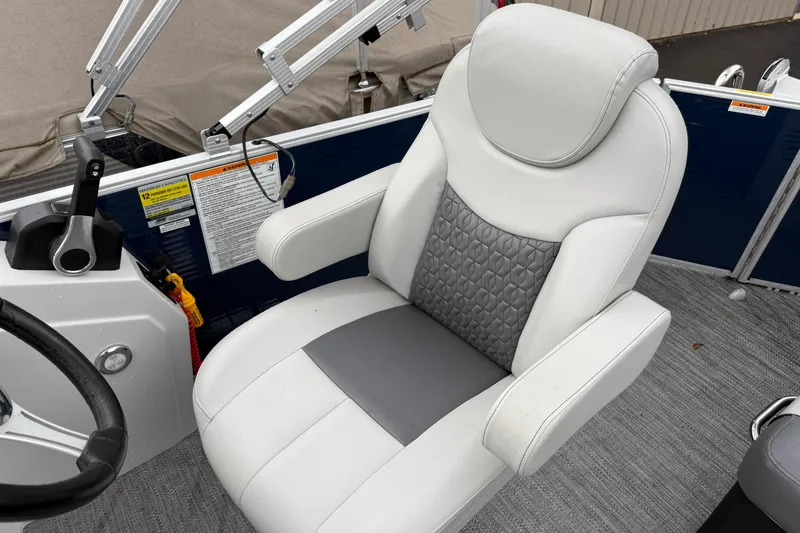Slide: The Image of Captain's chair on 2022 Godfrey Sweetwater boat, featuring gray and white upholstery. - 21