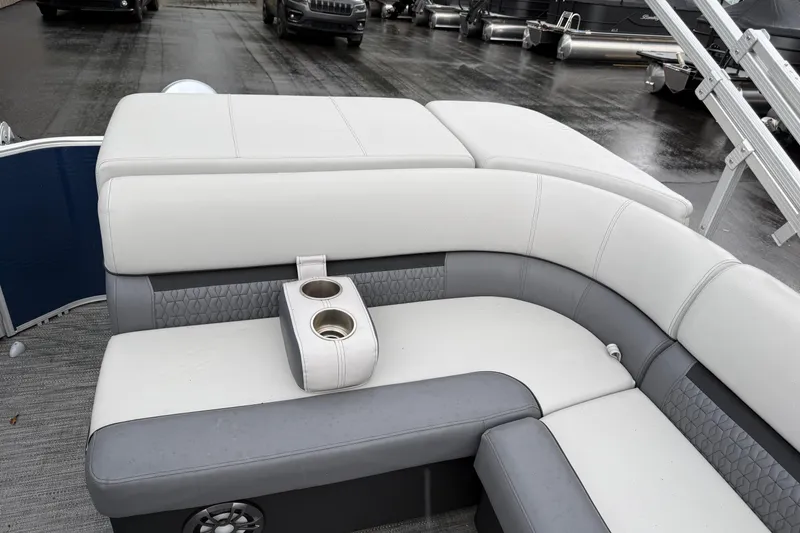 Slide: The Image of 2022 Godfrey Sweetwater pontoon boat interior with gray and white seating and cup holders. - 22