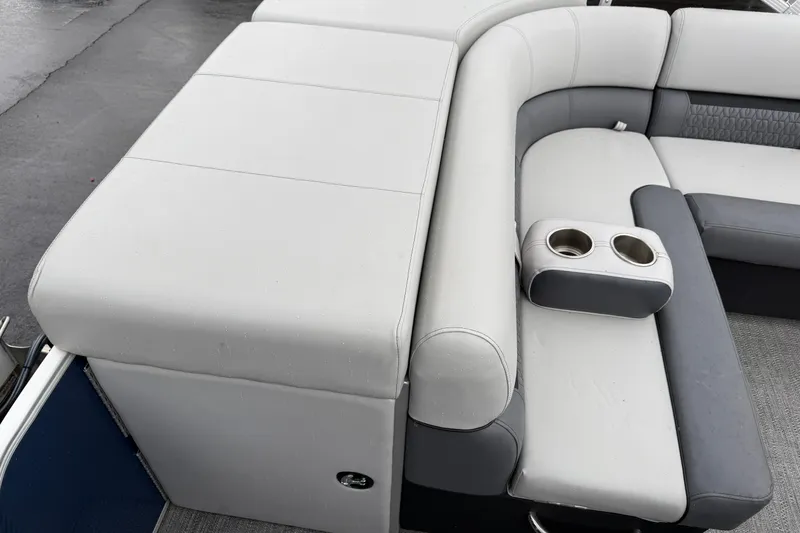 Slide: The Image of 2022 Godfrey Sweetwater boat interior with cushioned seating and cup holders. - 24