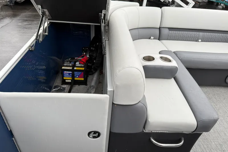 Slide: The Image of 2022 Godfrey Sweetwater boat interior with storage compartment and seating area. - 25