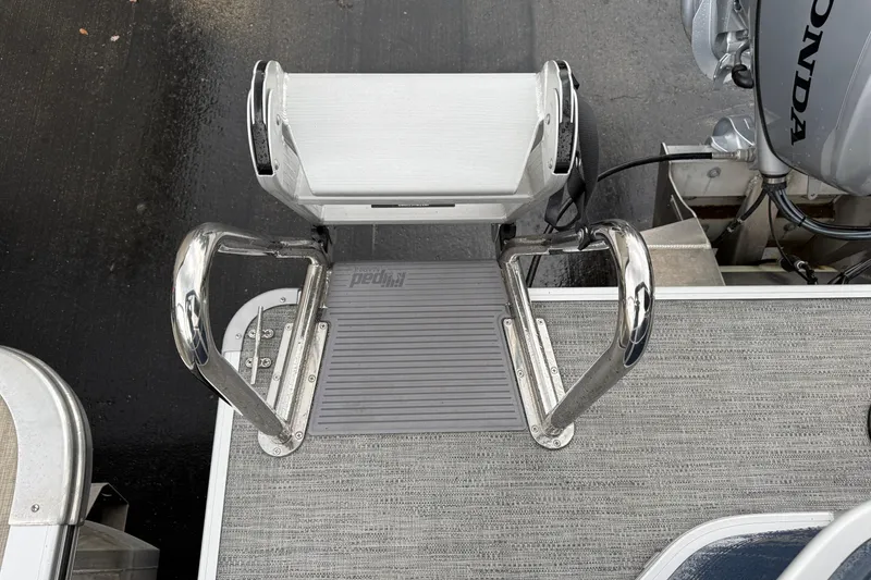 Slide: The Image of 2022 Godfrey Sweetwater boat ladder with Honda motor, featuring sturdy metal handles. - 26