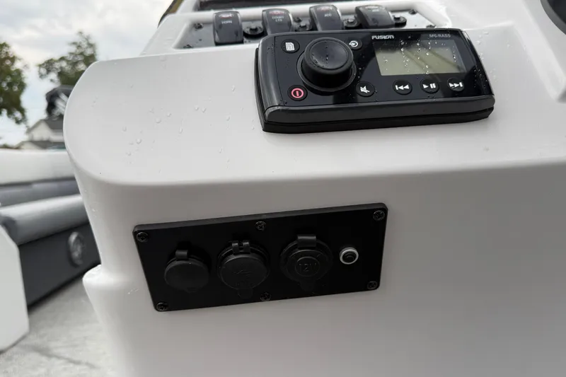 Slide: The Image of Control panel of 2022 Godfrey Sweetwater boat with audio system and switches. - 28