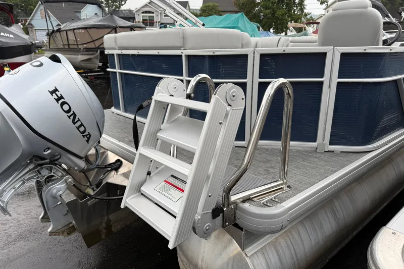 Slide: The Image of 2022 Godfrey Sweetwater pontoon boat with Honda motor and boarding ladder. - 6