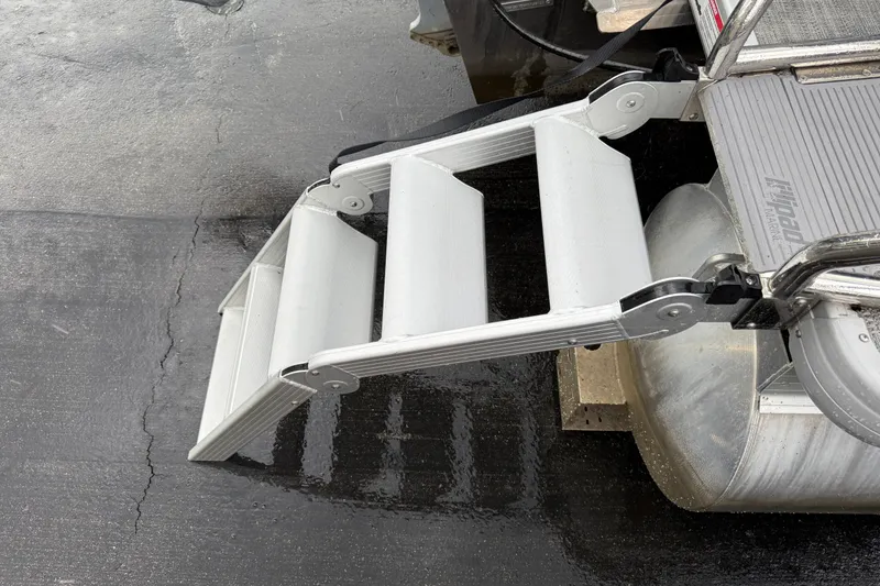 Slide: The Image of Folding boat ladder on 2022 Godfrey Sweetwater pontoon, wet dock surface. - 7