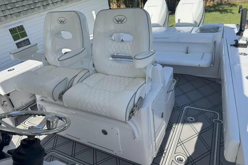 Slide: The Image of 2023 Southport 30 FE boat interior with luxurious white seating and modern design. - 11