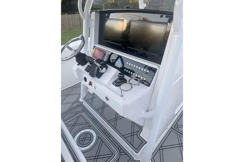 Slide: The Image of 2023 Southport 30 FE boat console with dual screens and modern controls. - 13
