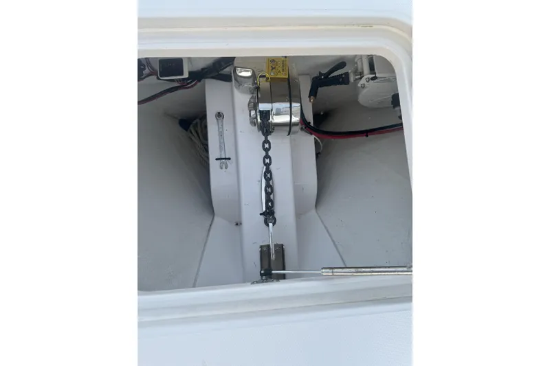Slide: The Image of Anchor chain compartment of 2023 Southport 30 FE boat, featuring winch and wiring. - 16