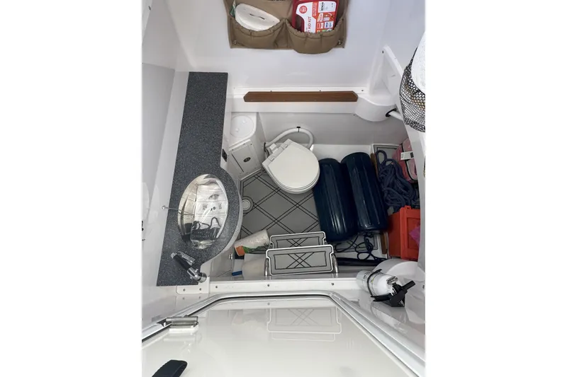 Slide: The Image of 2023 Southport 30 FE boat interior with sink, toilet, and storage compartments. - 17