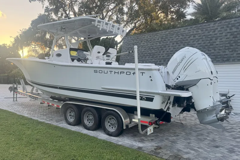 Slide: The Image of 2023 Southport 30 FE boat on trailer with dual Mercury engines, parked outdoors. - 6